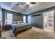 Spacious main bedroom with a king-size bed, two windows for natural light, and an attached bathroom at 39 Thorne Berry Dr, Hampton, GA 30228
