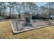 Fun playground area with a swing set, slide, and a wood chip ground cover, creating a safe and enjoyable space for children at 39 Thorne Berry Dr, Hampton, GA 30228