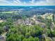 Aerial shot of the property at 3140 Cox Cemetery Road, showing the expansive wooded lot and surrounding landscape at 3140 Cox Cemetery Rd, Social Circle, GA 30025