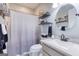 Stylish bathroom featuring a new vanity, round mirror and decorative shelving above the toilet at 3140 Cox Cemetery Rd, Social Circle, GA 30025