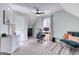 Cozy bedroom featuring a ceiling fan, desk and chair, and a comfortable seating area with pillows, creating an inviting workspace at 3140 Cox Cemetery Rd, Social Circle, GA 30025