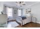 Bright bedroom featuring a metal bed frame, ceiling fan and neutral decor at 3140 Cox Cemetery Rd, Social Circle, GA 30025