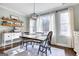 Dining room with modern light fixture, bright windows, and hardwood floors at 3140 Cox Cemetery Rd, Social Circle, GA 30025