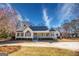 Beautiful exterior elevation of a home with large front porch and circular driveway and a lush landscaped yard at 3140 Cox Cemetery Rd, Social Circle, GA 30025