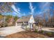 Exterior view features a charming white house with a spacious driveway and a fenced backyard with a cozy gazebo area at 3140 Cox Cemetery Rd, Social Circle, GA 30025