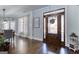 Entryway with hardwood floors, elegant lighting, and a decorative front door leading to a dining area at 3140 Cox Cemetery Rd, Social Circle, GA 30025