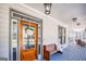 Inviting front porch with stylish decor, a cozy bench, and a view of the surrounding neighborhood at 3140 Cox Cemetery Rd, Social Circle, GA 30025