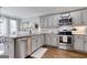 Well-lit kitchen with stainless steel appliances, granite countertops, and ample cabinet space at 3140 Cox Cemetery Rd, Social Circle, GA 30025