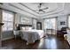 The primary bedroom boasts a tray ceiling, hardwood floors, and abundant natural light from large windows at 3140 Cox Cemetery Rd, Social Circle, GA 30025