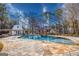 Lush backyard with a sparkling in-ground pool and waterfall, offering a perfect setting for relaxation and recreation at 3140 Cox Cemetery Rd, Social Circle, GA 30025