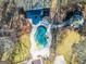 An overhead shot of the uniquely-shaped pool, patio, and outdoor sitting area at 3140 Cox Cemetery Rd, Social Circle, GA 30025