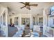 Spacious porch featuring comfortable seating, a ceiling fan, and glass paneled doors to the interior at 3140 Cox Cemetery Rd, Social Circle, GA 30025