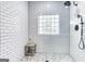 Tiled walk-in shower with glass block window, rain shower head and seating ledge at 3140 Cox Cemetery Rd, Social Circle, GA 30025