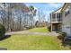 View of the home's side exterior featuring a screened porch, garage, and lush lawn at 122 Lawn Market, Sharpsburg, GA 30277