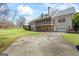 Side view of house with a long driveway leading to an attached garage and a spacious lawn at 122 Lawn Market, Sharpsburg, GA 30277