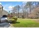 Large backyard with lush lawn, mature trees, and wooden deck and playset at 122 Lawn Market, Sharpsburg, GA 30277