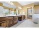 Bathroom featuring a double vanity with wood cabinets, tile flooring, and bright lighting at 122 Lawn Market, Sharpsburg, GA 30277