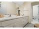 Well-lit bathroom with double sinks, neutral countertops, and a view into the toilet room at 122 Lawn Market, Sharpsburg, GA 30277