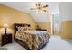 Cozy bedroom with sloped ceilings, a ceiling fan, and a patterned bedspread at 122 Lawn Market, Sharpsburg, GA 30277