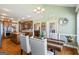 Open dining room view into the kitchen with hardwood floors at 122 Lawn Market, Sharpsburg, GA 30277