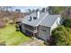 The rear exterior boasts a screened-in porch, a garage, and a spacious lawn at 122 Lawn Market, Sharpsburg, GA 30277