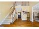 Bright foyer with hardwood floors, staircase with wooden railing, and a view of the second story at 122 Lawn Market, Sharpsburg, GA 30277