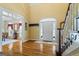 Bright foyer with hardwood floors, staircase with wooden railing, and a view of the front door at 122 Lawn Market, Sharpsburg, GA 30277