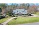 Charming front facade with a covered porch, dormer windows, and a manicured lawn at 122 Lawn Market, Sharpsburg, GA 30277