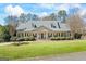 Charming single-story home with a covered front porch, manicured landscaping, and a well-maintained lawn at 122 Lawn Market, Sharpsburg, GA 30277