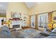 Bright living room with fireplace, plush seating, and vaulted ceiling at 122 Lawn Market, Sharpsburg, GA 30277