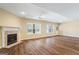 Bright living room with fireplace, large windows, and hardwood floors for a welcoming space at 122 Lawn Market, Sharpsburg, GA 30277