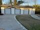Large garage with three parking spaces, concrete driveway, and grassy yard at 4100 Scott S Dr # 0, Forest Park, GA 30297