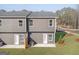 Backyard view of the townhome showcasing green space and back patio at 223 Ivey Ter # 34, Temple, GA 30179