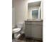 The bathroom features a granite countertop, gray cabinetry and a mirror at 223 Ivey Ter # 34, Temple, GA 30179
