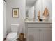 Bathroom featuring granite counters, framed art, and white patterned shower curtain at 223 Ivey Ter # 34, Temple, GA 30179