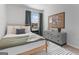 Comfortable bedroom with decorative pillows, cork board, and a window letting in natural light at 223 Ivey Ter # 34, Temple, GA 30179