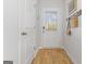 Bright entryway featuring a door with window, coat rack, and wood-look flooring at 223 Ivey Ter # 34, Temple, GA 30179