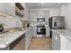 Modern kitchen features stainless steel appliances, granite countertops, and gray cabinets at 223 Ivey Ter # 34, Temple, GA 30179