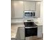 Kitchen features stainless steel appliances, granite countertops and gray cabinetry at 223 Ivey Ter # 34, Temple, GA 30179