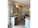 New kitchen features stainless steel appliances, granite countertops and gray cabinetry at 223 Ivey Ter # 34, Temple, GA 30179