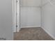 Bright walk-in closet with neutral carpet and wire shelving provides ample storage at 223 Ivey Ter # 34, Temple, GA 30179