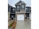 Modern townhome row featuring brick accents, garages, and neutral siding with contrasting black shutters at 225 Ivey Ter # 35, Temple, GA 30179