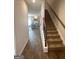 Entryway with wood-look flooring, staircase with wood railing, and a view of the kitchen at 225 Ivey Ter # 35, Temple, GA 30179