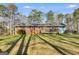 Expansive backyard features a brick house and a wooden deck, ideal for outdoor enjoyment and relaxation at 4864 Yeagar Rd, Douglasville, GA 30135