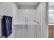 Bright bathroom with walk-in tub and shower, tiled walls, and modern fixtures at 4864 Yeagar Rd, Douglasville, GA 30135