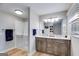 Bright bathroom with walk-in tub, double vanity with modern fixtures, and tiled shower at 4864 Yeagar Rd, Douglasville, GA 30135