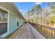 Expansive deck offers ample outdoor space with a wood railing, perfect for entertaining and enjoying the surrounding nature at 4864 Yeagar Rd, Douglasville, GA 30135