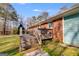 Back deck featuring wooden steps and a cozy spot for outdoor relaxation, with access to the backyard at 4864 Yeagar Rd, Douglasville, GA 30135