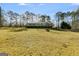 A cozy home with a large deck, surrounded by beautiful trees and a well-maintained grassy lawn at 4864 Yeagar Rd, Douglasville, GA 30135