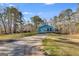 Scenic exterior view of a charming home with a spacious yard, surrounded by beautiful trees and a tranquil setting at 4864 Yeagar Rd, Douglasville, GA 30135
